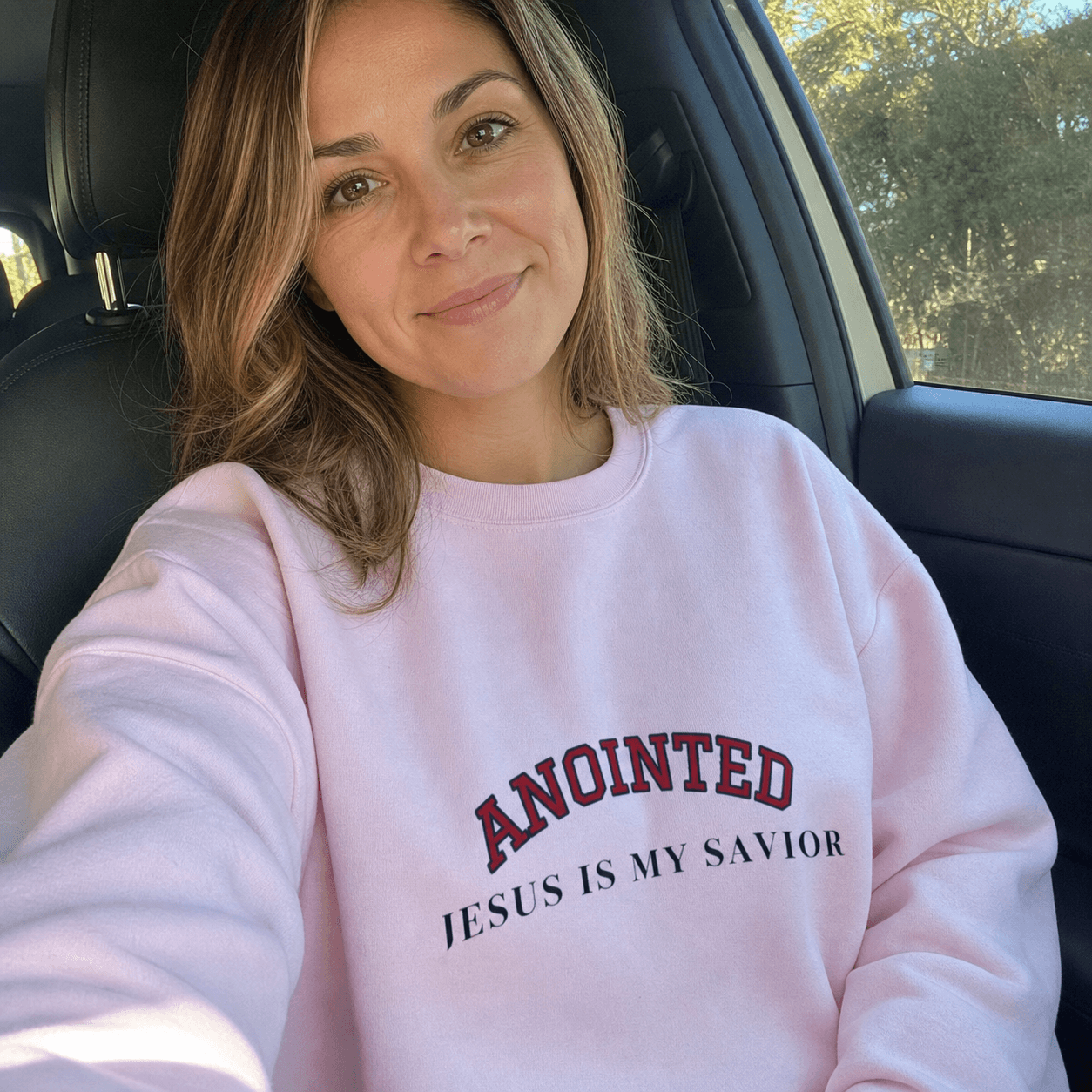 Customer selfie wearing the light pink My Jesus sweatshirt