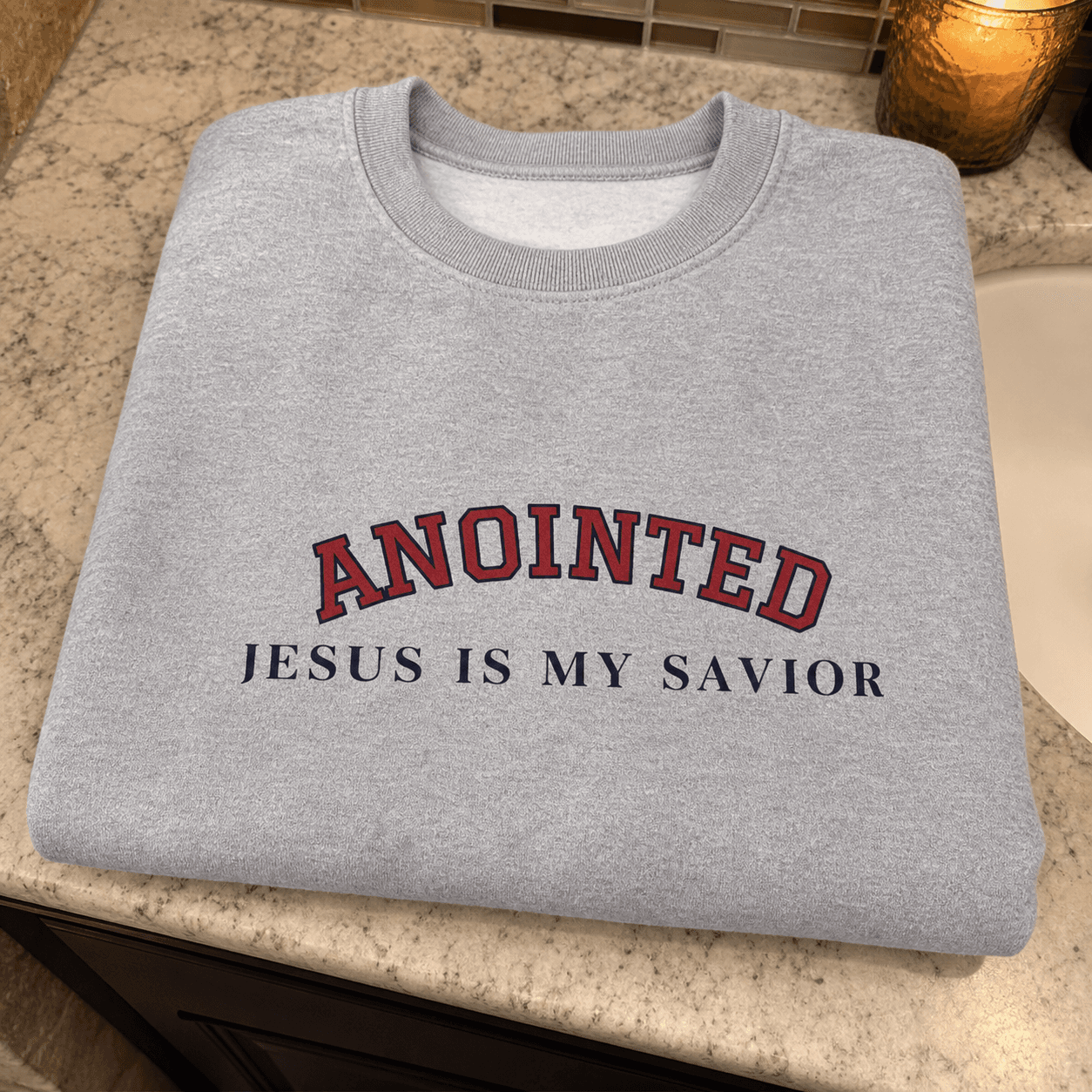 Close-up of the gray My Jesus sweatshirt graphic on a bathroom counter